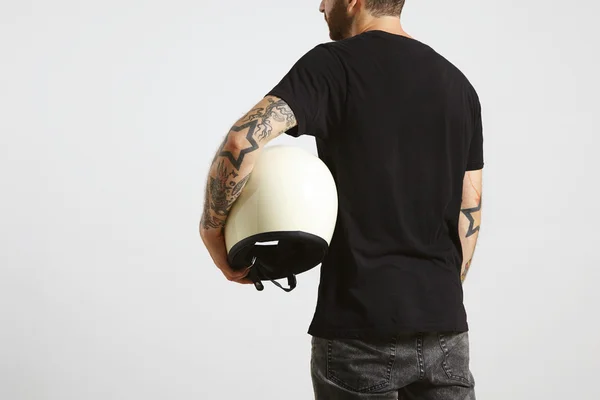 Guy holds ivory classic biker helmet — стоковое фото