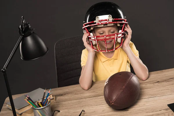 Smiling Schoolboy Putting American Football Helmet Table Ball Lamp Colour Стоковое Изображение