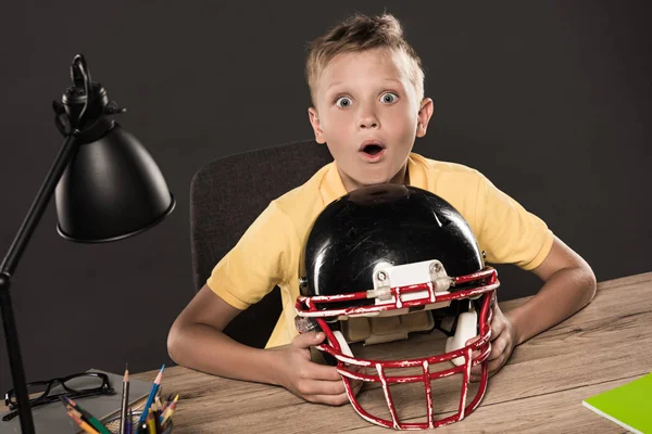 Shocked Schoolboy Sitting American Football Helmet Table Eyeglasses Lamp Colour Стоковое Фото