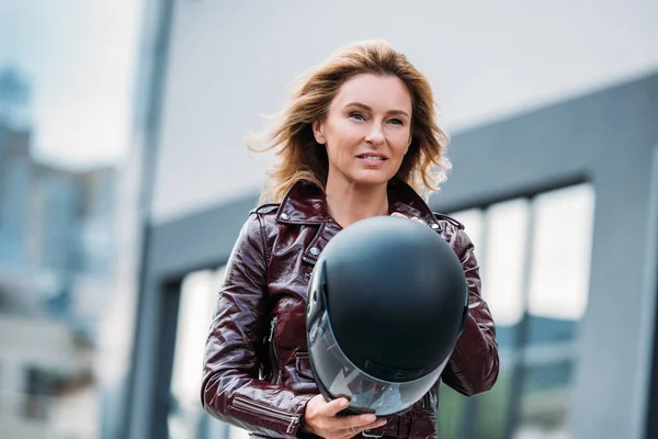 Beautiful Woman Leather Jacket Holding Motorcycle Helmet Street Looking Away — стоковое фото