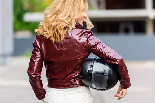 Back View Woman Leather Jacket Holding Motorcycle Helmet Street — стоковое фото